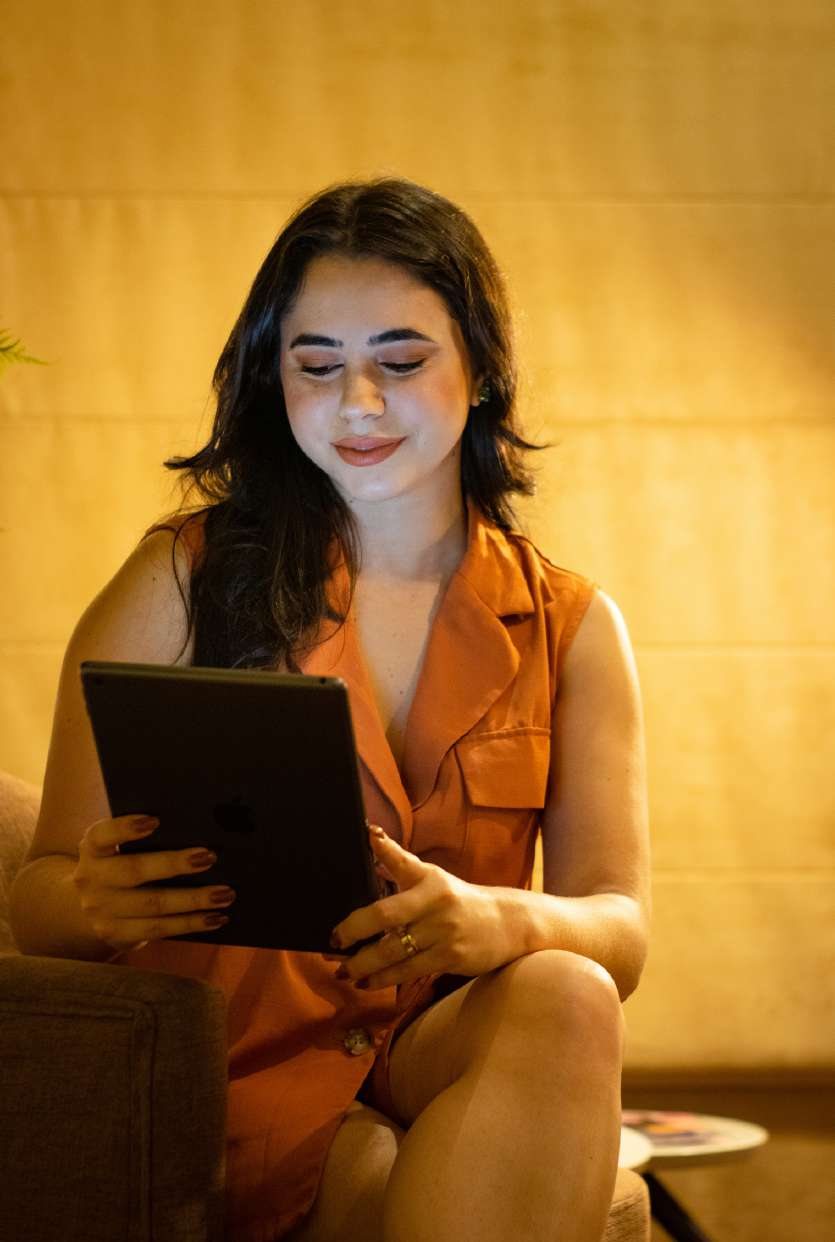 Iara Santos reviewing a lighting project on a tablet.